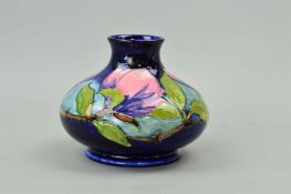 A MOORCROFT POTTERY SQUAT VASE, 'Magnolia' pattern on blue ground, impressed marks and painted