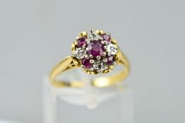 A LATE 20TH CENTURY RUBY AND DIAMOND ROUND CLUSTER RING, ring size M, stamped '18ct', approximate