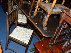 A DARK ERCOL OAK REFECTORY TABLE, and four chairs (5)