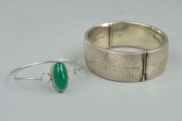 TWO BANGLES, the first designed with a central oval dyed green chalcedony, to the thin bangle with