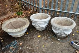 A PAIR OF COMPOSITE GARDEN PLANTERS, approximate diameter 50cm x height 36cm, together with a
