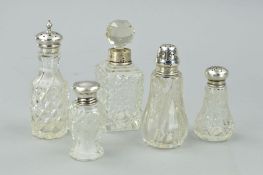 THREE SILVER TOPPED GLASS PEPPERETTES, a silver mounted glass toilet bottle with stopper and another