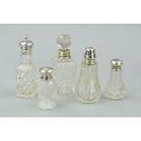 THREE SILVER TOPPED GLASS PEPPERETTES, a silver mounted glass toilet bottle with stopper and another
