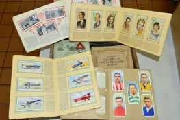 A COLLECTION OF CIGARETTE CARDS, loosely inserted and stuck into albums, to include Wills