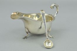 A GEORGE V SILVER SAUCE BOAT, of oval form, 'S' scroll handle, cast rim, three cabriole legs with