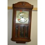 A MID 20TH CENTURY OAK CASED WALL CLOCK (winding key)