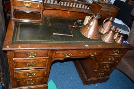 A 20TH CENTURY OAK DICKENS DESK, the top section with two drawers and shelving, green tooled leather