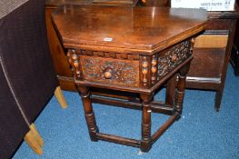 A REPRODUCTION GEORGIAN STYLE CARVED OAK HALL TABLE, the top folds over to form an octagonal top,