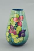 A MOORCROFT POTTERY TAPERED VASE, 'Bougainvillea' pattern on green/blue ground, impressed and