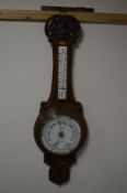A 20TH CENTURY OAK ANEROID BAROMETER, marked F J Gould (sd)