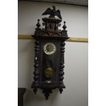 EARLY 20TH CENTURY MAHOGHANY VIENNA WALL CLOCK, brass and enamel circular dial, Roman numerals below