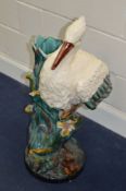 A LATE 20TH CENTURY GLAZED MAJOLICA STYLE UMBRELLA STAND, in the form of a standing Stork,