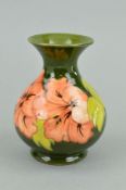 A SMALL MOORCROFT POTTERY VASE, Hibiscus pattern on green ground, paper label to base, approximate
