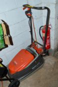A FLYMO TURBO COMPACT 300 ELECTRIC LAWN MOWER (Spares and Repairs) together with a workmate and a