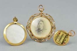THREE EARLY 20TH CENTURY PHOTOGRAPH PENDANTS, all of circular outline, two of plain design, one with