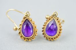 A PAIR OF 9CT GOLD AMETHYST DROP EARRINGS, each designed as a suspended pear shape amethyst within a