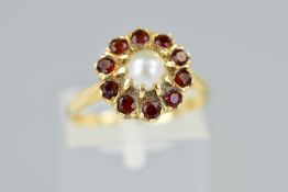 A 9CT GOLD CULTURED PEARL AND GARNET RING, designed as a central cultured pearl within a circular