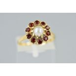 A 9CT GOLD CULTURED PEARL AND GARNET RING, designed as a central cultured pearl within a circular