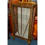 AN EDWARDIAN WALNUT SINGLE DOOR CHINA CABINET