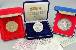 THREE CASED COINS, to include two commemorative silver jubilee coins for queen Elizabeth II, a