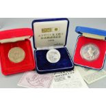 THREE CASED COINS, to include two commemorative silver jubilee coins for queen Elizabeth II, a