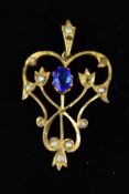 A EARLY 20TH CENTURY GEM PENDANT, designed with a central oval blue paste within an openwork