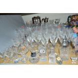 A COLLECTION OF CUT/ETCHED GLASSWARE, including drinking glasses, decanters, wheelcut glasses, a