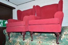 A PAIR OF MODERN RED UPHOLSTERED WINGED ARMCHAIRS