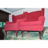 A PAIR OF MODERN RED UPHOLSTERED WINGED ARMCHAIRS