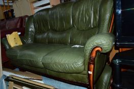 A GREEN LEATHER WOOD FRAMED THREE PIECE SUITE, with footstool (4)