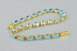 A TOPAZ BRACELET, designed as pear shape topaz links to the push piece clasp, stamped 14k, length