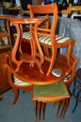 A YEW WOOD CIRCULAR EXTENDING DINING TABLE, and four chairs (5)