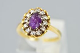 A MID 20TH CENTURY 18CT GOLD AMETHYST AND DIAMOND OVAL CLUSTER RING, oval head measuring