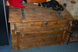 A VINTAGE PINE SLOPED TRUNK, with iron banded hinges and four pivetted handles to each corners and