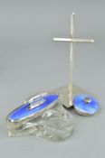 AN ENAMEL DRESSING TABLE SET AND A HARROW SCHOOL OF ART SILVER CROSS STAND, the dressing table set