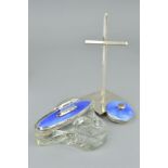 AN ENAMEL DRESSING TABLE SET AND A HARROW SCHOOL OF ART SILVER CROSS STAND, the dressing table set