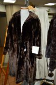 A SEAL FUR FULL LENGTH COAT, with valuation receipt from 1970, together with a faux fur animal print