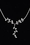 A FLORAL NECKLACE, designed as a central V section of leaves interspaced by circular cubic