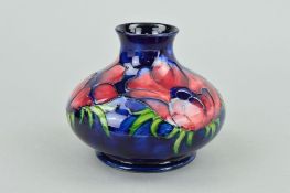 A MOORCROFT POTTERY SQUAT VASE, 'Anemone' pattern on blue ground, impressed and painted marks to