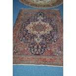 A 20TH CENTURY WOOLLEN CAUCASION RUG, red and deep blue ground, with foliate design, 205cm x