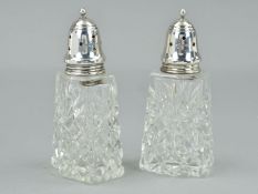 A NEAR PAIR OF ELIZABETH II SILVER MOUNTED GLASS SUGAR CASTOR, the screw on covers with star