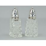 A NEAR PAIR OF ELIZABETH II SILVER MOUNTED GLASS SUGAR CASTOR, the screw on covers with star