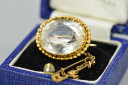 A LATE VICTORIAN 9CT GOLD ROCK CRYSTAL BROOCH, the oval rock crystal within a fancy claw setting