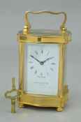 A MAPPIN AND WEBB BRASS CASED CARRIAGE CLOCK OF SERPENTINE FORM, enamel dial with Roman numerals,