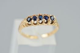 A FIVE STONE SAPPHIRE RING, designed as five circular cut sapphires with an open gallery,