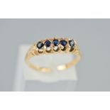 A FIVE STONE SAPPHIRE RING, designed as five circular cut sapphires with an open gallery,