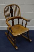 AN 18TH CENTURY AND LATER YEW WOOD AND ELM SPINDLE BACK ROCKING CHAIR, with a splat back centre
