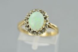 A 9CT OPAL AND DIAMOND CLUSTER RING, the central opal cabochon within a single cut diamond surround,