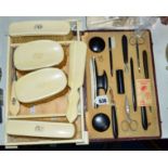 A CASED EBONY MANICURE SET AND AN IVORY DRESSING SET, tray stamped Harrods (2)