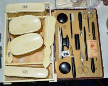 A CASED EBONY MANICURE SET AND AN IVORY DRESSING SET, tray stamped Harrods (2)